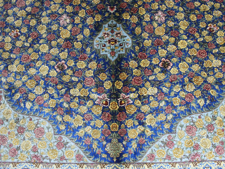 blue field on Tabriz silk rug